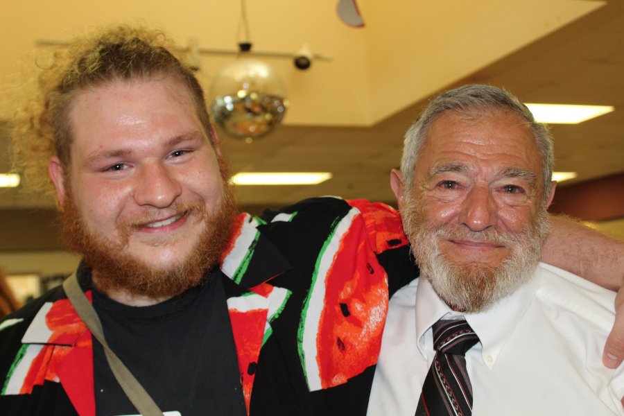 Two bearded men smiling.