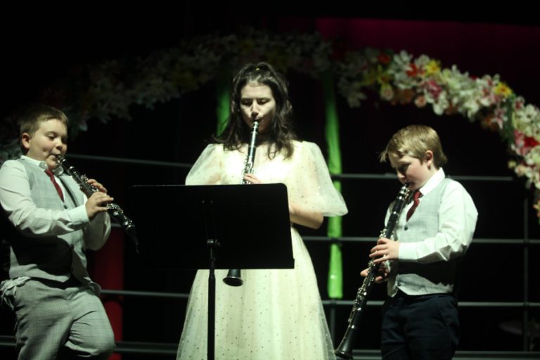 3 young people playing clarinets.