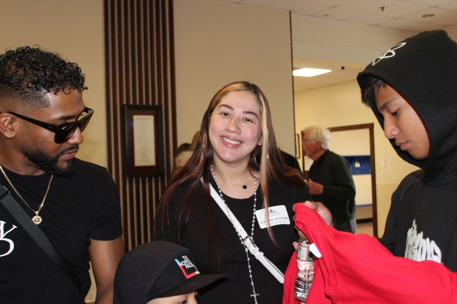 A group of three young people wearing black.