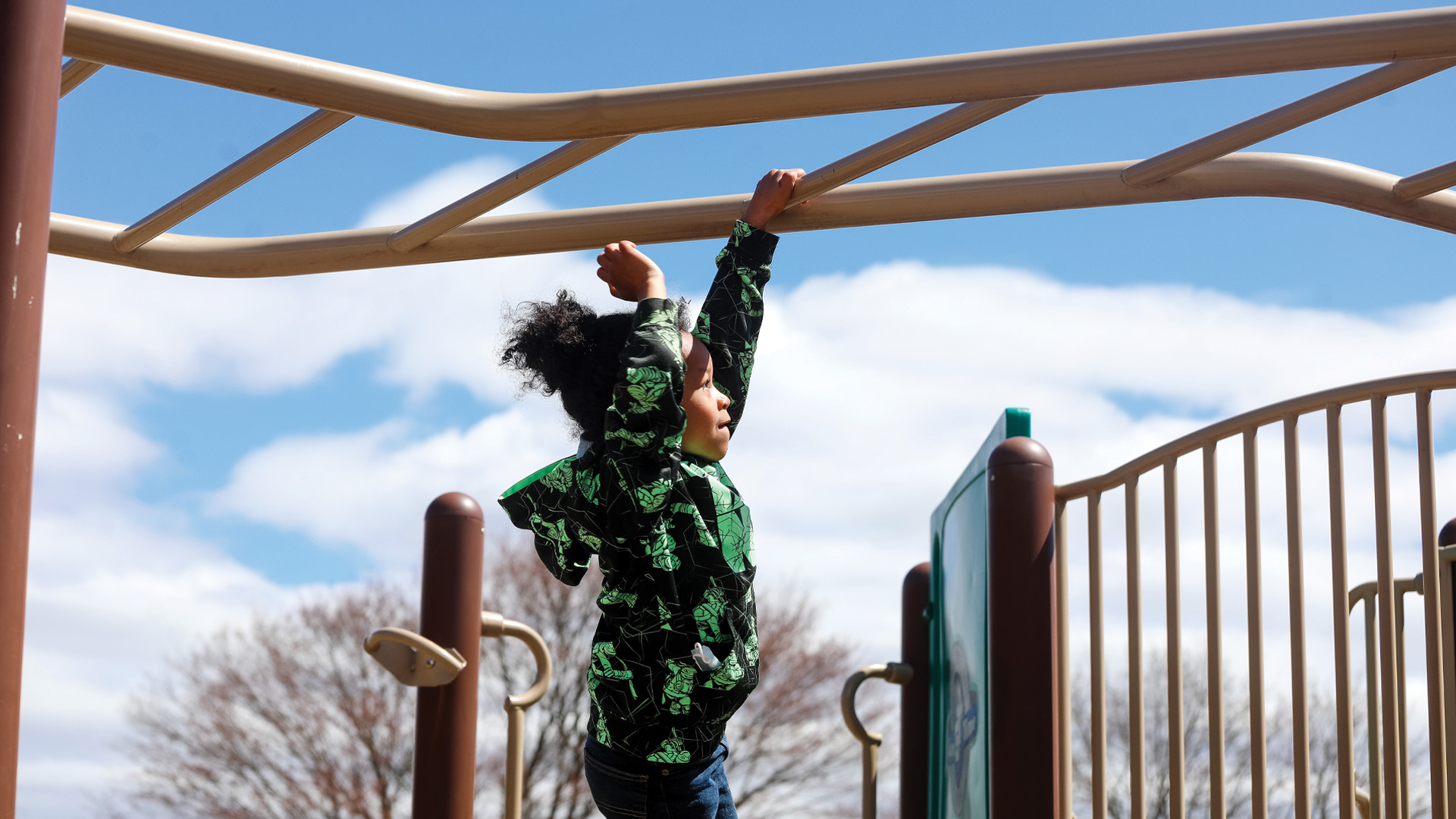 student on monkey bars