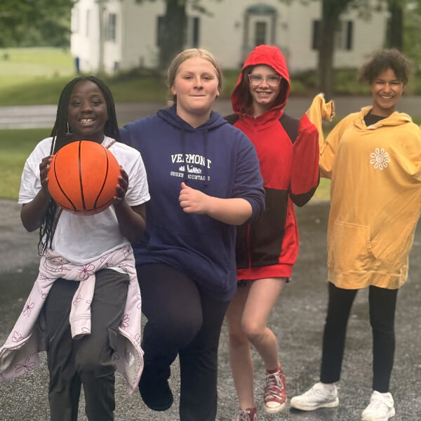Girls playing basketball together