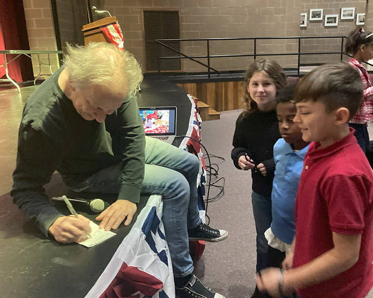 Pete signs autographs
