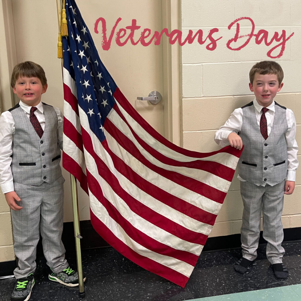 Kurn Hattin students holding up the United States flag