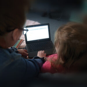 Teacher and child looking at iPad.